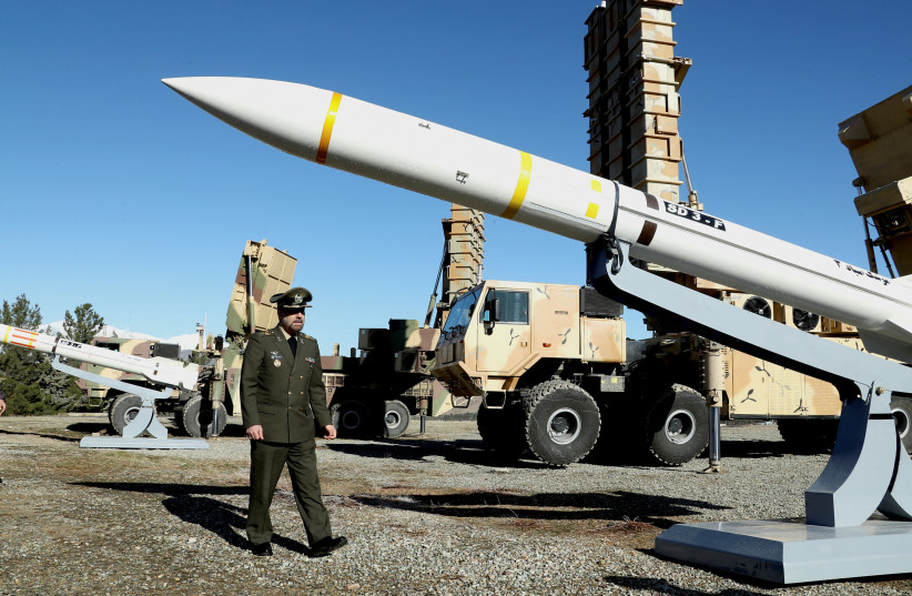  Iran's Defense Minister Brigadier General Mohammad-Reza Ashtiani walks near an Iranian missile during an unveiling ceremony in Tehran, Iran, in this picture obtained on February 17, 2024. (credit: Iran's Defense Ministry/WANA (West Asia News Agency)/Handout via REUTERS)