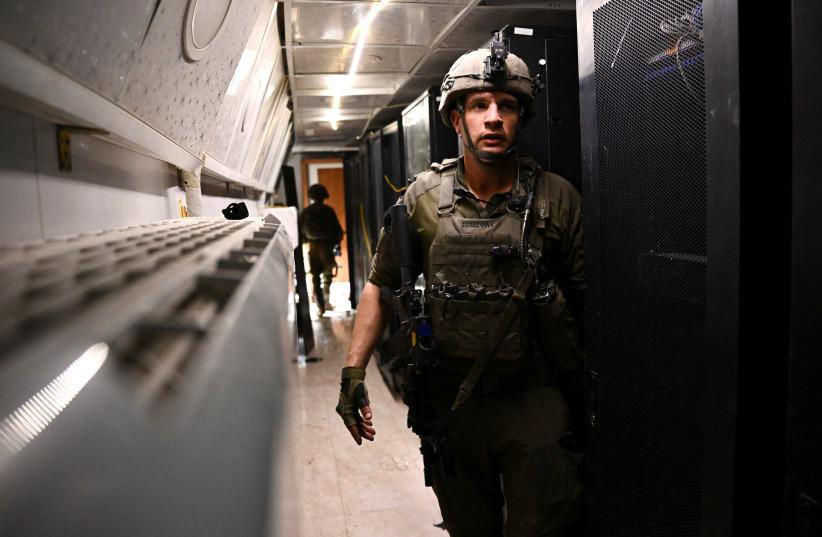  An Israeli soldier walks in what the military described as a Hamas command tunnel running partly under UNRWA headquarters, amid the ongoing conflict between Israel and the Palestinian Islamist group Hamas, in the Gaza Strip, February 8, 2024. (credit: DYLAN MARTINEZ/REUTERS)