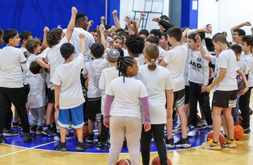  Jared Armstrong and Israeli children in one of his free basketball clinics in Ashkelon, Israel (credit: Courtesy of Jared Armstrong)