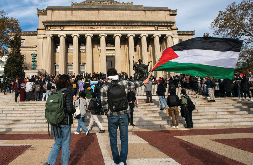  A PROTESTER waves a Palestinian flag during a rally at Columbia University in New York, in November.  (credit: Eduardo Munoz/Reuters)