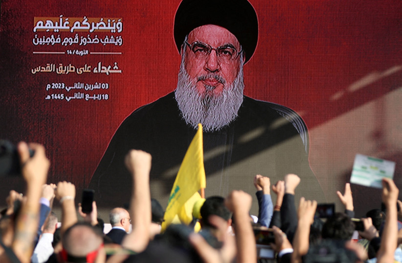  Lebanon's Hezbollah leader Sayyed Hassan Nasrallah appears on a screen as he addresses his supporters during a ceremony to honour fighters killed in the recent escalation with Israel, in Beirut's southern suburbs, Lebanon November 3, 2023. (credit: REUTERS/MOHAMED AZAKIR)