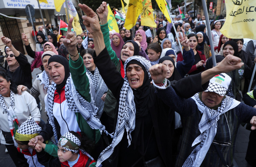 Palestinian women carry flags and gesture during a demonstration in support of Palestinians in Gaza, amid the ongoing conflict between Israel and the Palestinian Islamist group Hamas, in Beirut, Lebanon March 2, 2024.