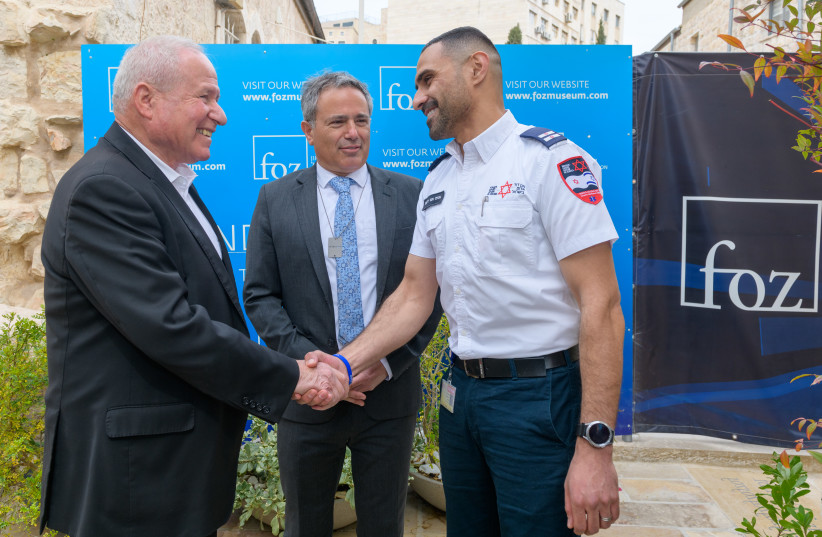 SHIN BET Director Avi Dichter (L) greets Anir Abu Dabes, a Bedouin MDA medic from Rahat, who was among the first responders to arrive in Ofakim, saving lives while under fire, as Avi Benlolo, CEO of The Abraham Global Peace Initiative, who spearheaded the tribute, looks on. (credit: Shmulik Cohen)