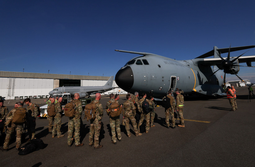  Soldiers stand near Belgian Air Force Airbus A400M Atlas, as it is loaded with humanitarian aid that is destined for an airdrop over Gaza, at Belgian military airport in Melsbroek, Belgium March 4, 2024. (credit: REUTERS/YVES HERMAN)