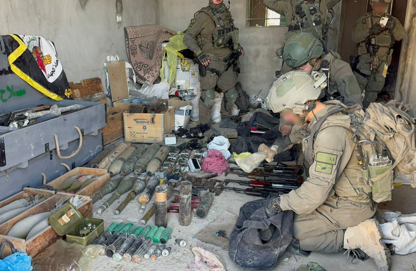  Soldiers from the Counter-Terrorism Unit discover weapons, munitions, and rockets inside a warehouse next to a school in Khan Yunis that was previously used as a shelter for civilians, March 5, 2024. (credit: IDF SPOKESPERSON'S UNIT)
