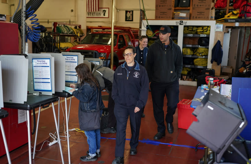  La gente vota en un colegio electoral dentro de una estación de bomberos durante las elecciones primarias del Supermartes en San Francisco, California, EE.UU. 5 de marzo 2024. (credit: REUTERS)