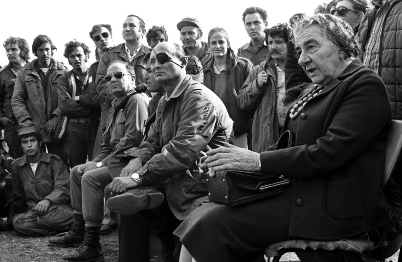  THEN-PRIME MINISTER Golda Meir is accompanied by defense minister Moshe Dayan, as they meet with IDF soldiers on the Golan Heights during the 1973 Yom Kippur War. Egypt and Syria launched an attack against Israel on Yom Kippur – during the month of Ramadan.  (credit: REUTERS)