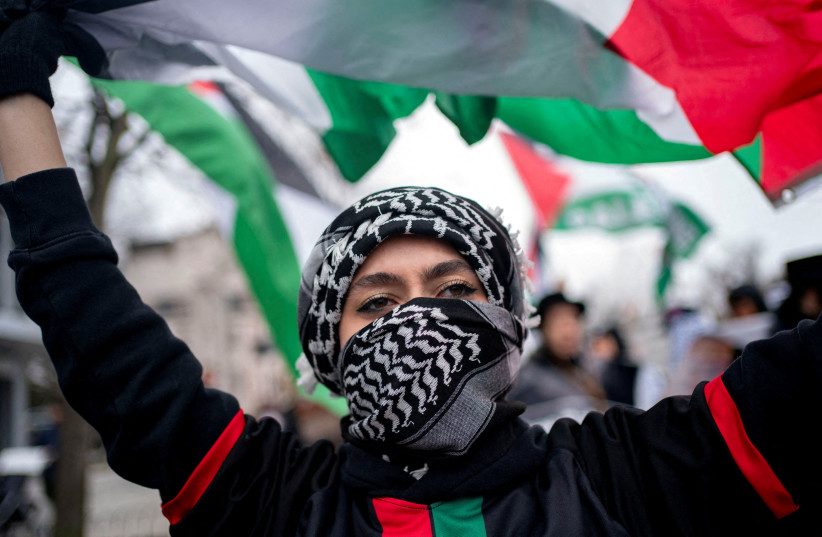  A pro-Palestinian demonstrator waves a Palestinian flag while marching to call for a ceasefire in Gaza, amid the ongoing conflict between Israel and the Palestinian Islamist group Hamas, during a protest in Washington, U.S., March 2, 2024. (credit: Bonnie Cash/Reuters)
