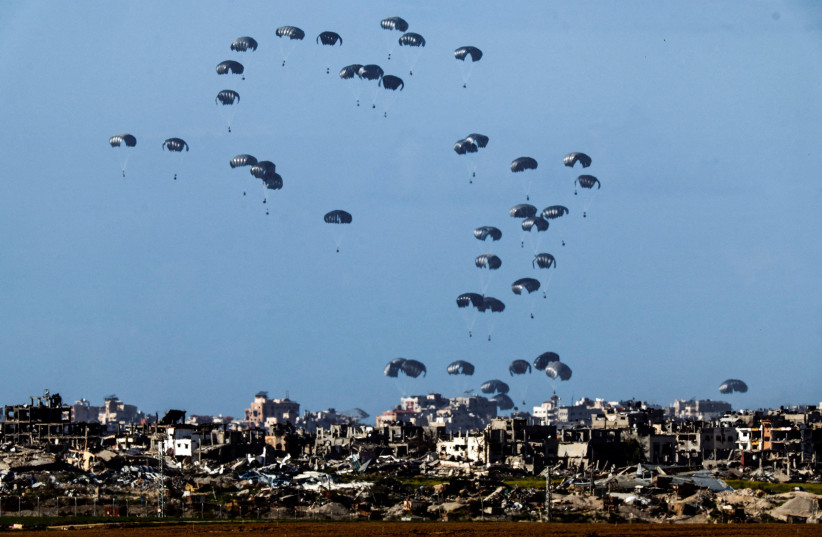  Packages fall towards northern Gaza, after being dropped from a military aircraft, amid the ongoing conflict between Israel and the Palestinian group Hamas, as seen from Israel's border with Gaza in southern Israel March 7, 2024. (credit: REUTERS/AMIR COHEN)