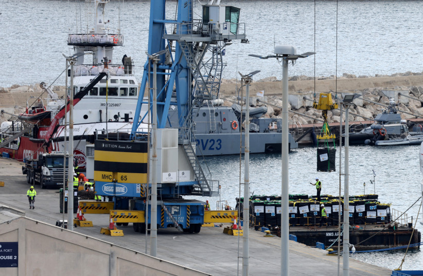  Humanitarian aid for Gaza is loaded onto platform in Larnaca, March 9, 2024 (credit: REUTERS/YIANNIS KOURTOGLOU)
