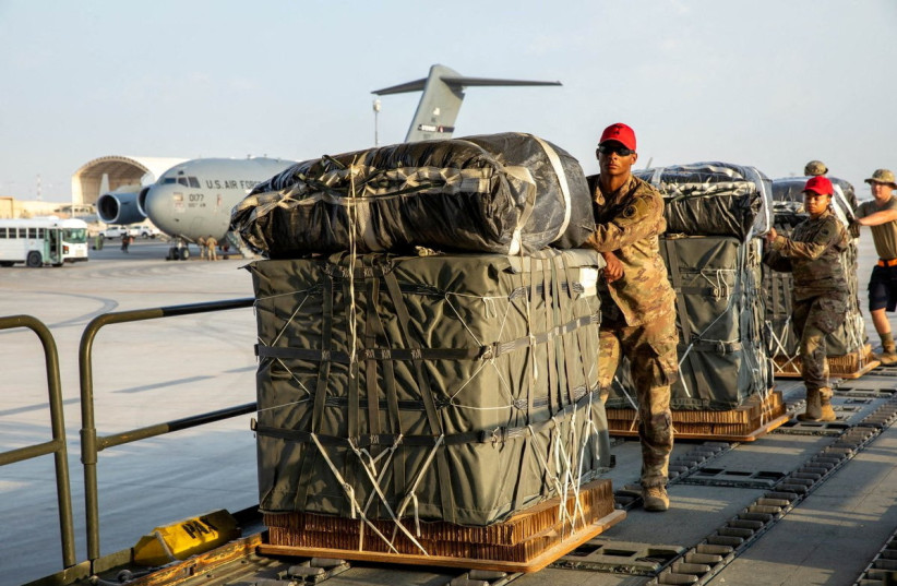 U.S. Air Force members work on the preparation of a humanitarian aid drop for Gaza residents, in this picture released on March 5, 2024.  (credit:  US Central Command via X/Handout via REUTERS )