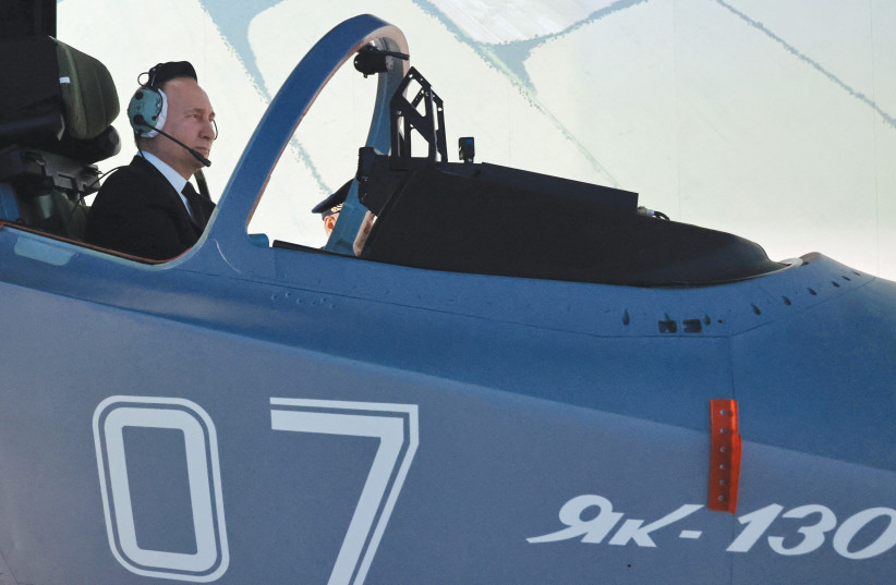  RUSSIAN PRESIDENT Vladimir Putin sits in a cockpit of a flight simulator at the Higher Military Aviation School of Pilots in Krasnodar, Russia, last week. When Putin invaded Ukraine two years ago, he envisioned a swift blitz on the Ukrainian capital, severing its government in a matter of days, say (credit: SPUTNIK/REUTERS)