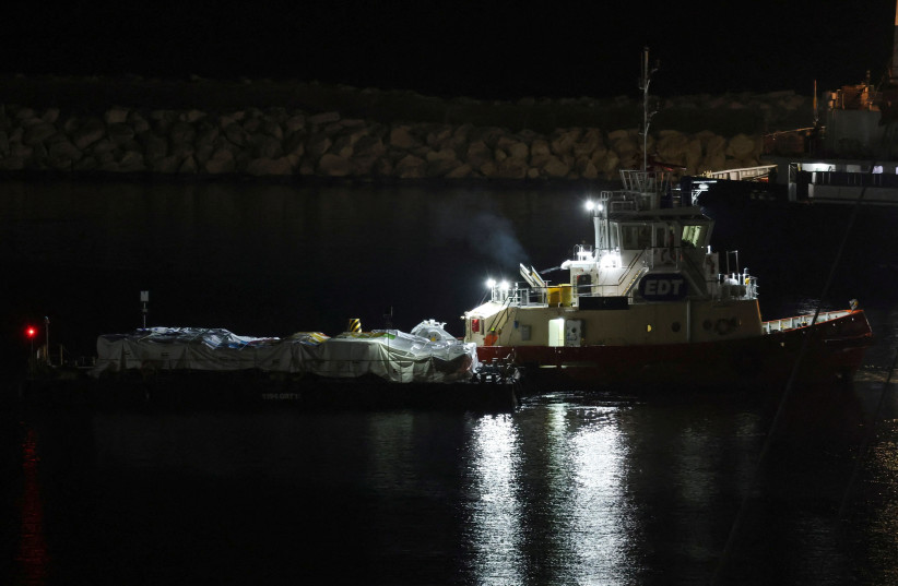  A platform loaded with humanitarian aid for Gaza is guided by a tugboat at the port of Larnaca, Cyprus March 10, 2024. (credit: REUTERS/YIANNIS KOURTOGLOU)