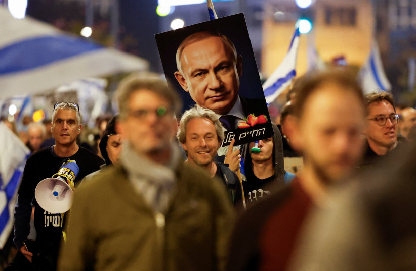  A placard with an image of Israeli Prime Minister Benjamin Netanyahu is seen as people take part in a protest against Netanyahu's government, amid the ongoing conflict between Israel and the Palestinian Islamist group Hamas from Gaza, in Tel Aviv, Israel March 2, 2024.  (credit: CARLOS GARCIA RAWLINS/REUTERS)