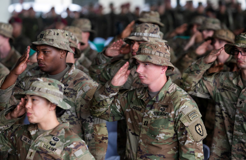  American soldiers salute as the national anthem plays during the opening ceremonies of Salaknib, the annual bilateral exercise between Philippine and U.S. Army, at Fort Magsaysay, Nueva Ecija province, Philippines, March 13, 2023. (credit: REUTERS/LISA MARIE DAVID)