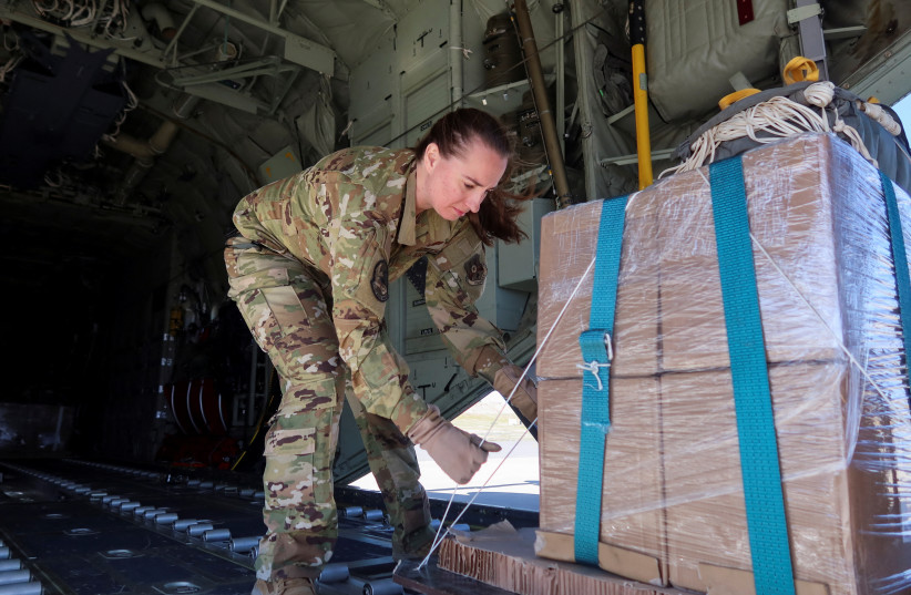  U.S. military personnel load aid packages into a plane that will be airdropped over Gaza, in Zarqa, Jordan March 12, 2024. (credit: JEHAD SHELBAK/REUTERS)