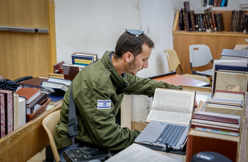  Israeli soldiers who were released for a short break from the war in the Gaza Strip against Hamas study Torah at the Har Etzion Yeshiva in the Jewish settlement of Alon Shvut, in Gush Etzion, on January 16, 2024.  (credit: GERSHON ELINSON/FLASH90)