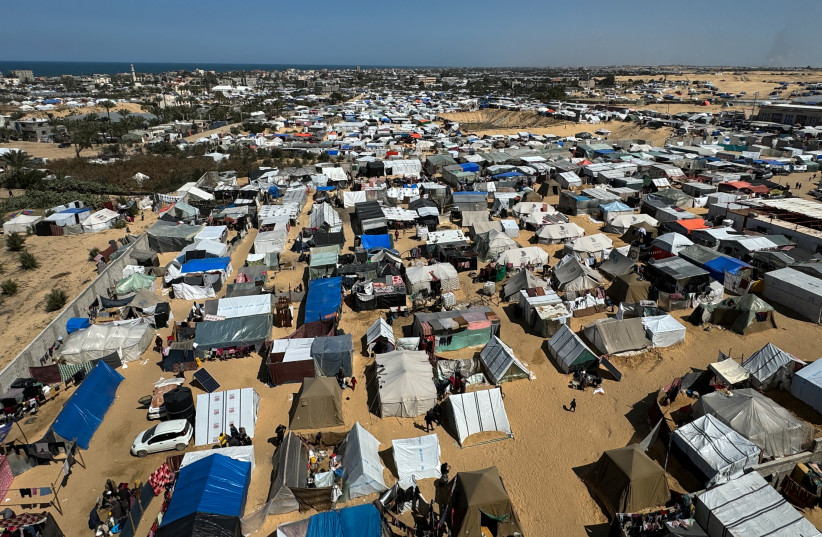  Displaced Palestinians, who fled their houses due to Israeli strikes, shelter in a tent camp, amid the ongoing conflict between Israel and the Palestinian Islamist group Hamas, in Rafah, in the southern Gaza Strip March 11, 2024. (credit: REUTERS/ BASSAM MASOUD)