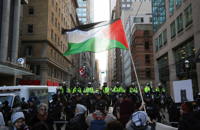  olice officers stand guard as supporters of a ceasefire in Gaza gather to protest near the venue of a Liberal Party fundraising rally featuring Canada's Prime Minister Justin Trudeau, amid the ongoing conflict between Israel and the Palestinian Islamist group Hamas, in Toronto, Ontario, Canada,  (credit: REUTERS/CARLOS OSORIO)