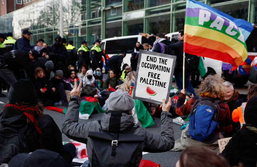  Protesters block an intersection near the House of Representatives in solidarity with the people in Gaza as they request the government to insist on a permanent ceasefire in Gaza, in The Hague, Netherlands, March 8, 2024. (credit: PIROSCHKA VAN DE WOUW/REUTERS)