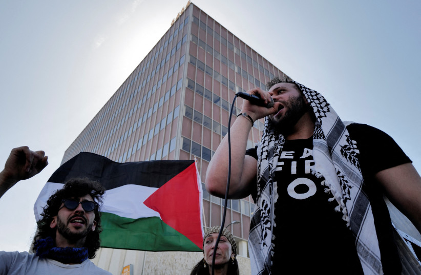  A person uses a microphone during a protest near the perimeter of the 96th Academy Awards, amid the ongoing conflict between Israel and the Palestinian Islamist group Hamas, in Los Angeles, California, U.S., March 10, 2024.  (credit: REUTERS/CARLIN STIEHL)