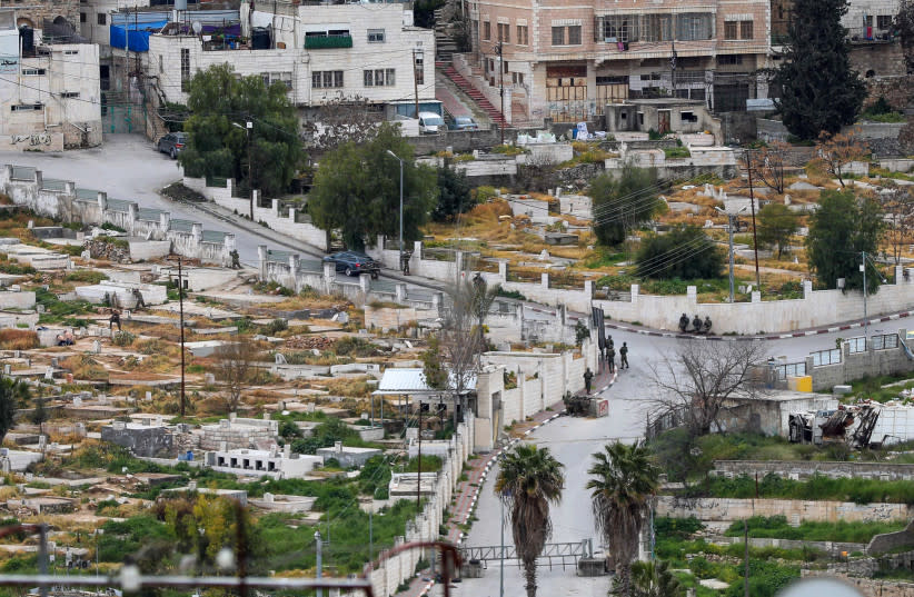  Fuerzas de seguridad israelíes toman posición en el lugar de un intento de ataque a tiros en el cementerio viejo, en la Cisjordania de Hebrón, 16 de marzo de 2024. (credit: WISAM HASHLAMOUN/FLASH90)