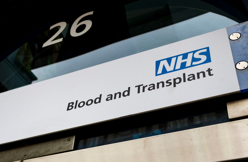 An NHS Blood and Transplant sign is seen at the Blood Donor Center, following the announcement of the re-balloting voted in the long-running dispute over pay and staffing, in London, Britain, February 18, 2023. (credit: MAY JAMES/REUTERS)