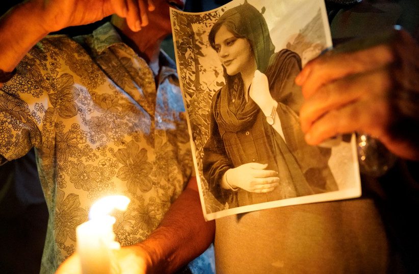  A image of Zhina Mahsa Amini at a candlelit vigil following her death, outside the Wilshire Federal Building in Los Angeles, California, U.S., September 22, 2022.  (credit: BING GUAN/REUTERS)