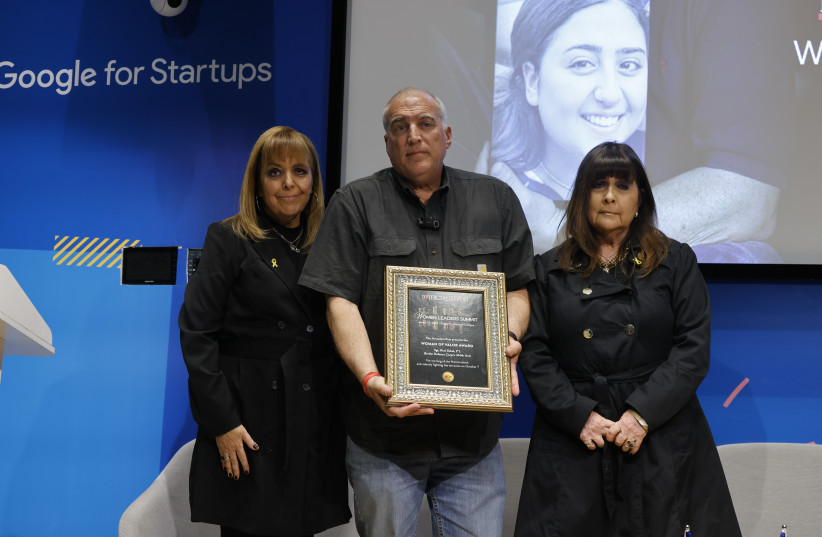  Eyal Eshel (center) receives the Woman of Valor award on behalf of his daughter, the late Sgt. Roni Eshel on March 27, 2024 (credit: MARC ISRAEL SELLEM)