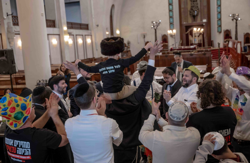  Haredi Jews and family members of Gaza hostages celebrate Purim. (credit: CHEN SCHIMMEL)