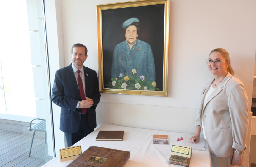  President Isaac Herzog and First Lady Michal Herzog with a portrait of the president's grandmother, Rabbanit Sarah Herzog (credit: MARC ISRAEL SELLEM)