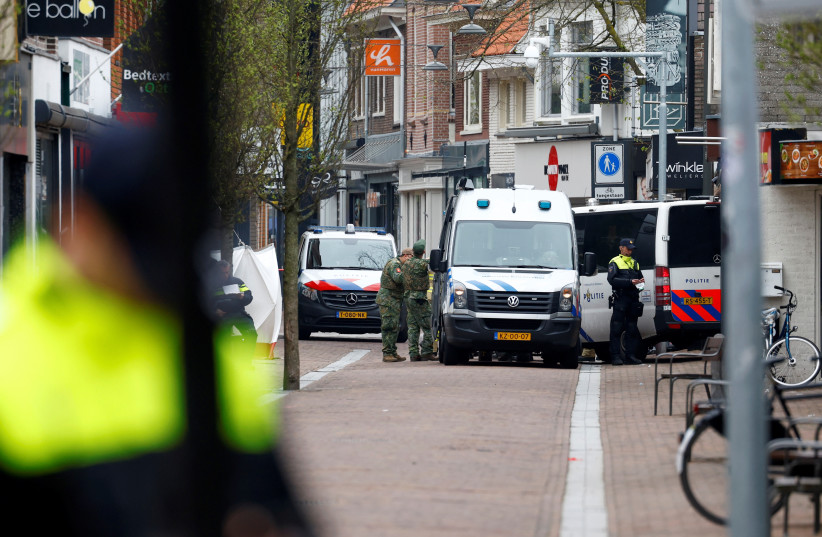Dutch police officers work near the Cafe Petticoat, where several people are being held hostage in Ede, Netherlands March 30, 2024. (credit: PIROSCHKA VAN DE WOUW/REUTERS)