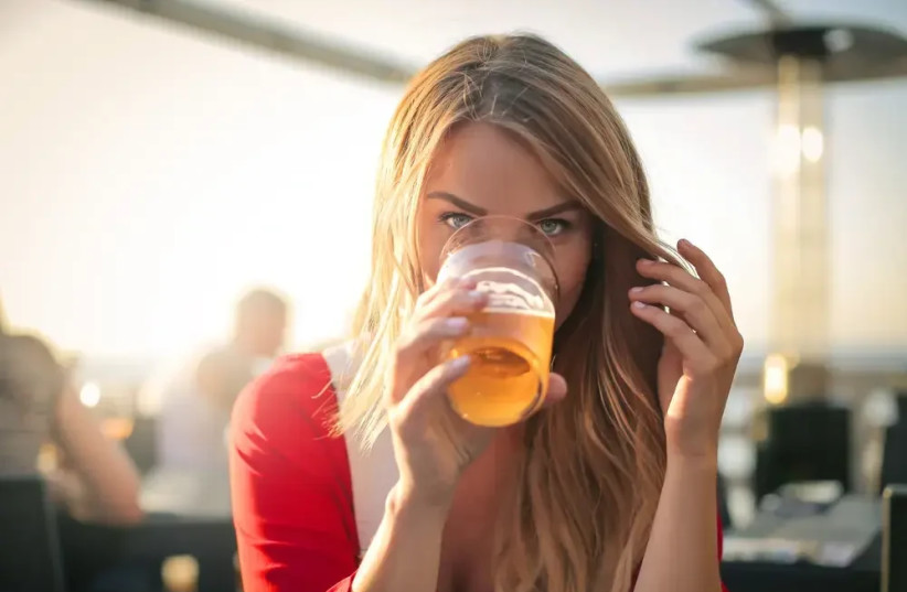   Woman drinking beer (credit: SHUTTERSTOCK)
