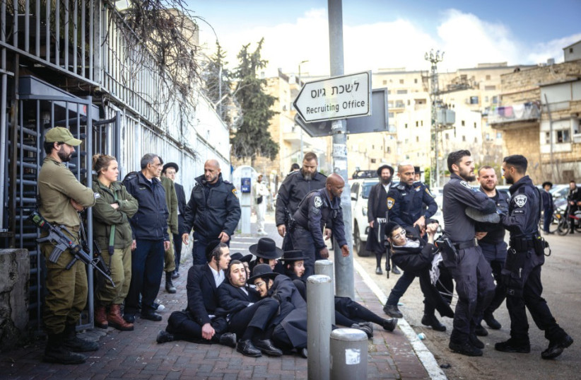  Ultra-Orthodox protest outside the Draft Office in Jerusalem. (credit: CHAIM GOLDBEG/FLASH90)