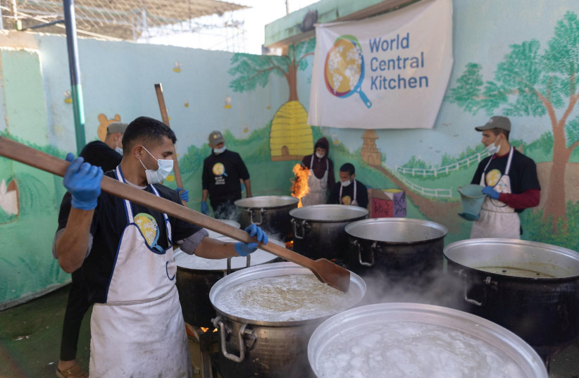  Members of ''World Central Kitchen'' prepare food for Palestinians, in the location given as Gaza, amid the ongoing conflict between Israel and Hamas, in this picture released on March 21, 2024 and obtained from social media.  (credit: @chefjoseandres via X/via REUTERS )