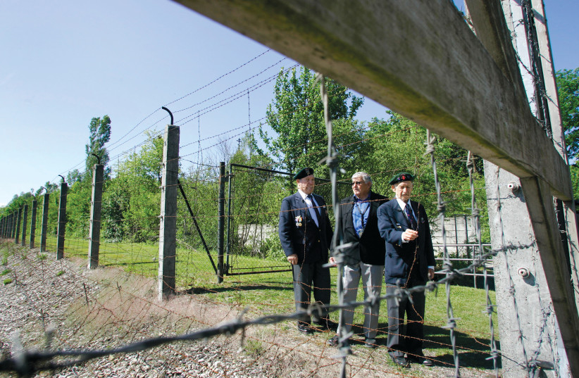  American Jewish World War II veterans Don Golde (right), Cy Mermelstein (left), and Shep Waldman (center) stand next to the barbed wire fence of the concentration camp at the 62nd memorial of the liberation in Dachau on May 13, 2007.  (credit: Michaela Rehle/Reuters)