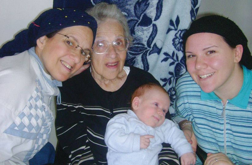  SARAH GOLDSTEIN (L) with her daughter Nechama, her mother, and her mother’s first great-grandchild.  (credit: Moshe Goldstein)
