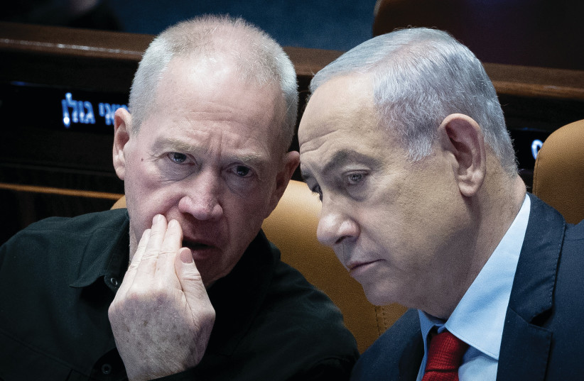  PRIME MINISTER Benjamin Netanyahu and Defense Minister Yoav Gallant confer in the Knesset plenum last month. Many Israelis are thirsty for a decisive Israeli victory and a long-term strategy in order to finally live in peace and without existential threat, the writer asserts.  (credit: YONATAN SINDEL/FLASH90)