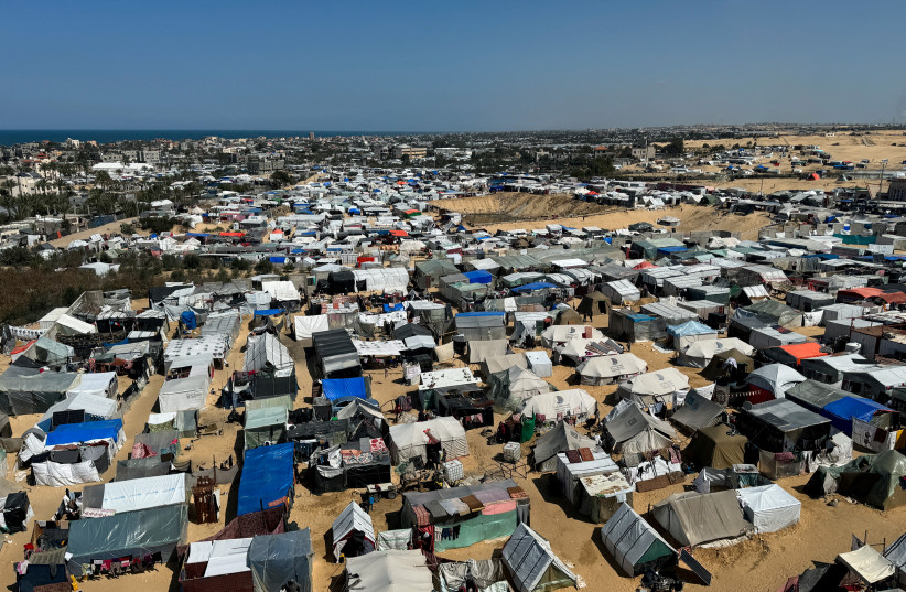  Displaced Palestinians, who fled their houses due to Israeli strikes, shelter in a tent camp, amid the ongoing conflict between Israel and the Palestinian Islamist group Hamas, in Rafah, in the southern Gaza Strip March 11, 2024. (credit: REUTERS/BASSAM MASOUD)