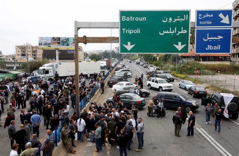  Supporters of the Lebanese Forces Party block a main highway in protest over the fate of a local official, who security forces later said was killed by a group of Syrians in an attempted carjacking, in Byblos Lebanon April 8, 2024. (credit: REUTERS/MOHAMED AZAKIR)