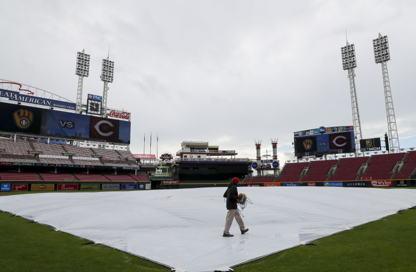  Apr 11, 2024; Cincinnati, Ohio, USA; A general view of the tarp on the field before the game between the Milwaukee Brewers and the Cincinnati Reds at Great American Ball Park. The game is postponed due to inclement weather.  (credit: Katie Stratman/USA TODAY Sports)