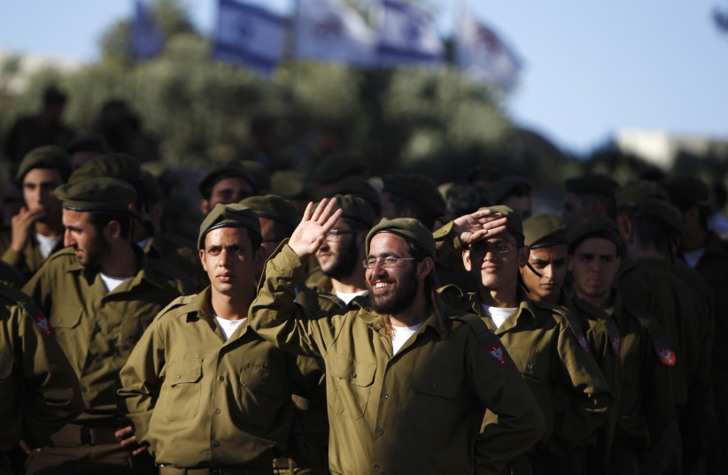  Israeli soldiers of the Netzah Yehuda Haredi infantry battalion are seen during their swearing-in ceremony in Jerusalem May 26, 2013, marking the end of their basic training in the Israeli Defense Forces. Israel clinched a deal on Wednesday to abolish wholesale exemptions from military service for  (credit: REUTERS)