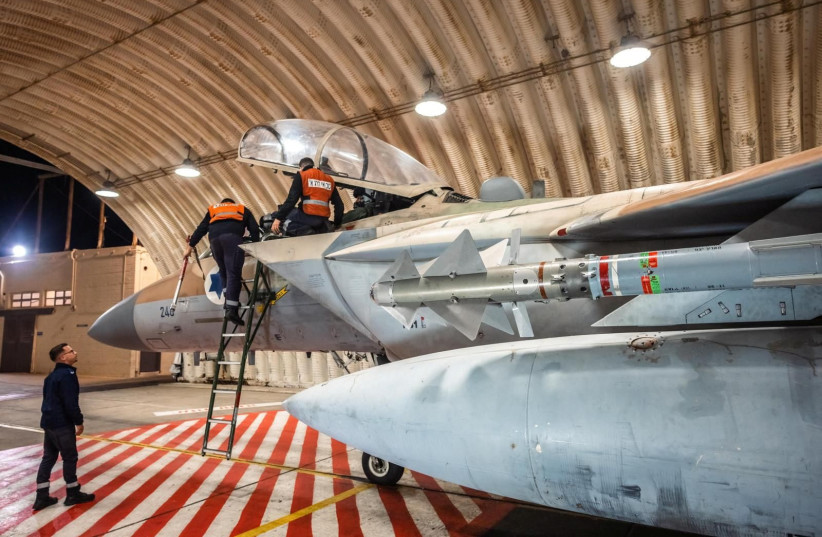  Equipos trabajan en un F-15 Eagle de la Fuerza Aérea de Israel en un hangar, tras una misión de intercepción de un ataque con drones y misiles iraníes en Israel, en esta imagen proporcionada el 14 de abril de 2024. (crédito: Fuerzas de Defensa de Israel/Handout via REUTERS)