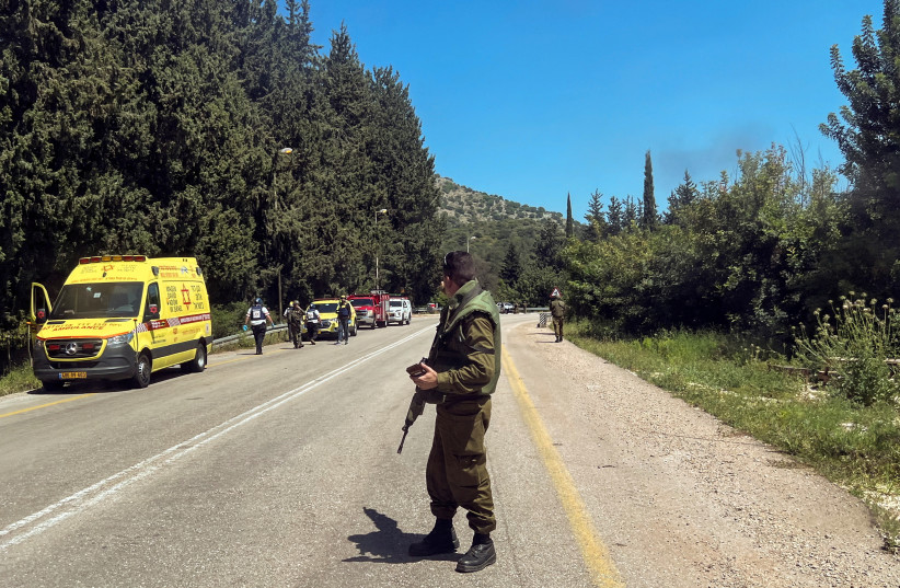  An Israeli soldier looks on at a scene, after it was reported that people were injured, amid ongoing cross-border hostilities between Hezbollah and Israeli forces, near Arab al-Aramashe in northern Israel April 17, 2024. (credit:  REUTERS/Avi Ohayon)