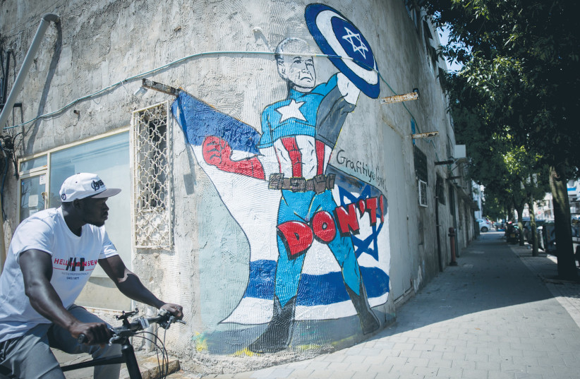  A MURAL in Tel Aviv depicts US President Joe Biden as a superhero defending Israel against the Iranian attack. On the strategic level, Israel suffered a whopping loss as Iran pierced American and Israeli deterrence frameworks with apparent impunity, the writer maintains. (credit: MIRIAM ALSTER/FLASH90)