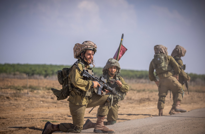  Israeli soldiers from the Netzah Yehuda Battalion patrol near the Israeli-Gaza border, October 20, 2023. (credit: YONATAN SINDEL/FLASH90)