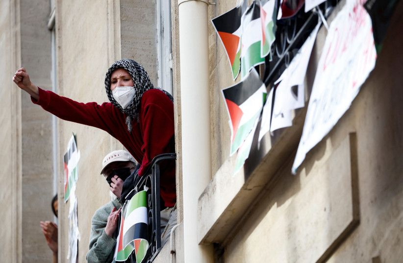 Masked youths take part in the occupation of a building of the Sciences Po University and block the entry in support of Palestinians in Gaza, during the ongoing conflict between Israel and the Palestinian Islamist group Hamas, in Paris, France, France, April 26, 2024. (credit: BENOIT TESSIER/REUTERS)