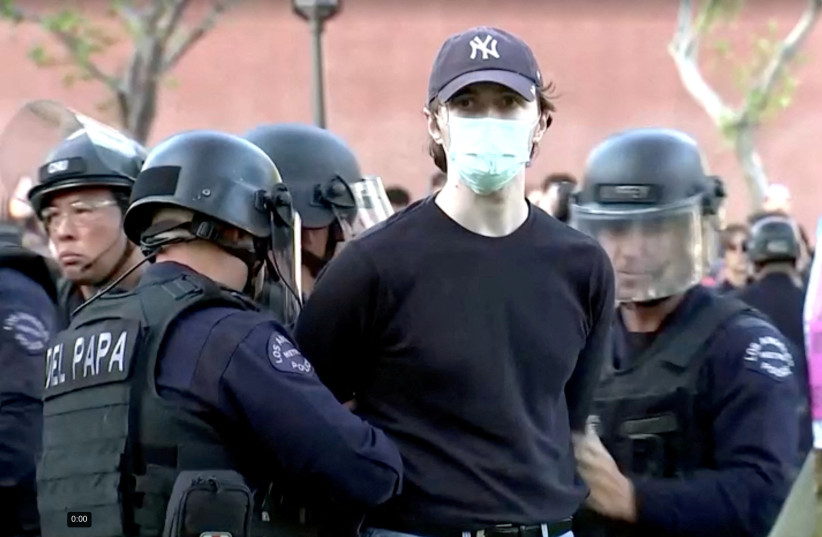  Police arrest a pro-Palestinian protester at USC campus in Los Angeles, California, U.S., April 24, 2024, in this still image taken from video (credit: REUTERS TV)