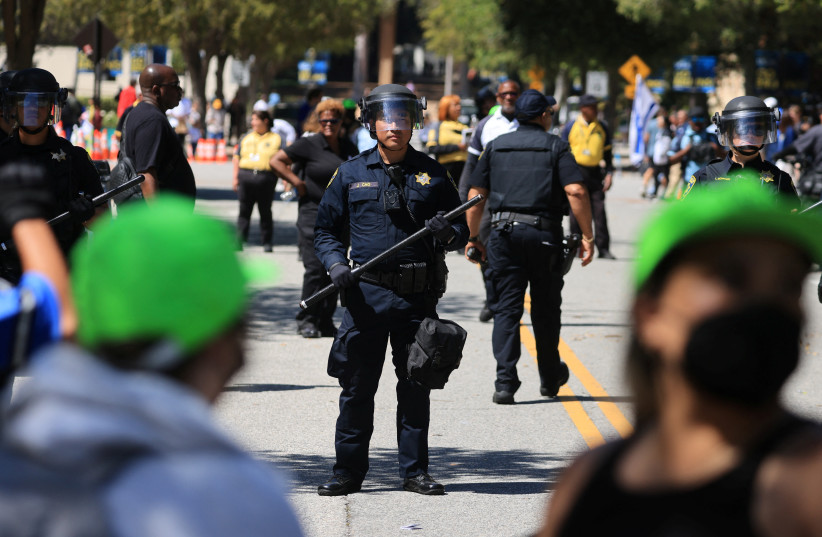 University of California Police officers stand guard during demonstrations by protesters in support of Palestinians in Gaza and pro-Israel counter-protesters, amid the ongoing conflict between Israel and the Palestinian Islamist group Hamas, at the University of California Los Angeles (UCLA) in Los  (credit: DAVID SWANSON/REUTERS)