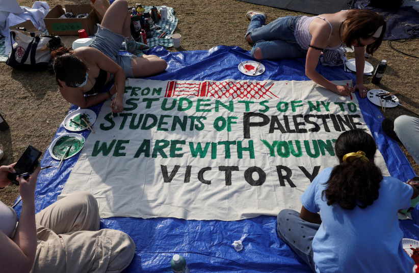  Students at Columbia University paint a response to a message written by Palestinians in Rafah thanking students for their support as they continue to maintain a protest encampment on campus in support of Palestinians, during the war between Israel and Hamas, April 28, 2024.  (credit: REUTERS/CAITLIN OCHS)